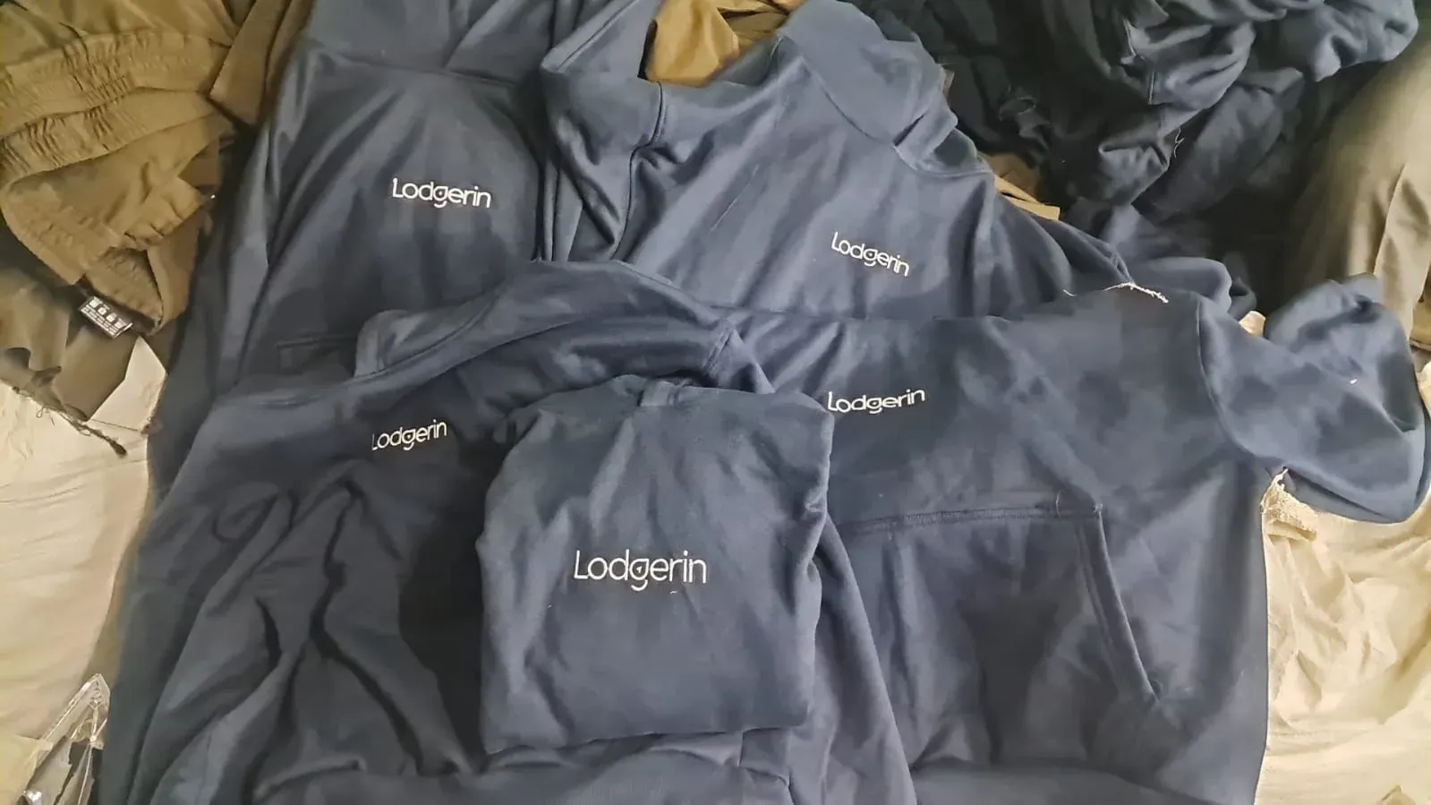 Pedido Lodgerin de hoodies navy con logo bordado fabricados por Texlink en Mumbai